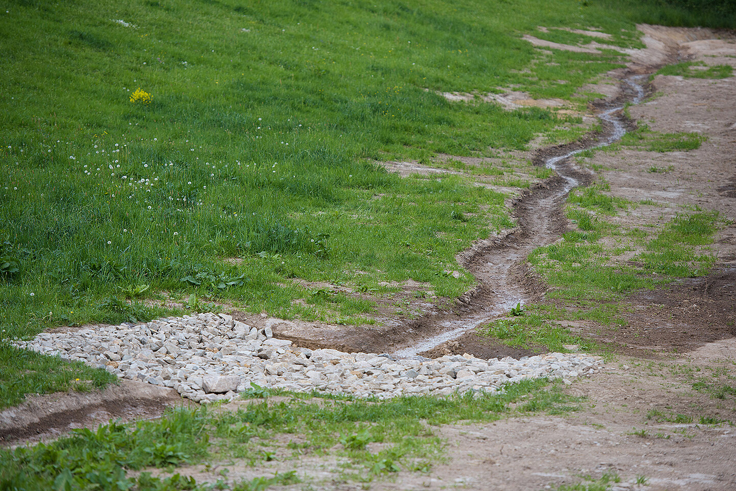 Ein Weg auf dem sich ein kleiner Kieshaufen befindet.