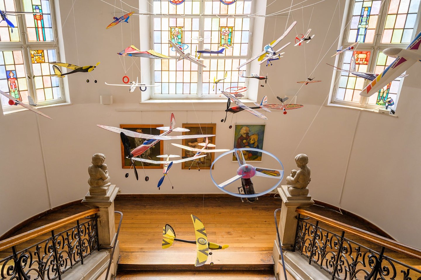 Spielzeugflugzeuge hängen im Treppenhaus